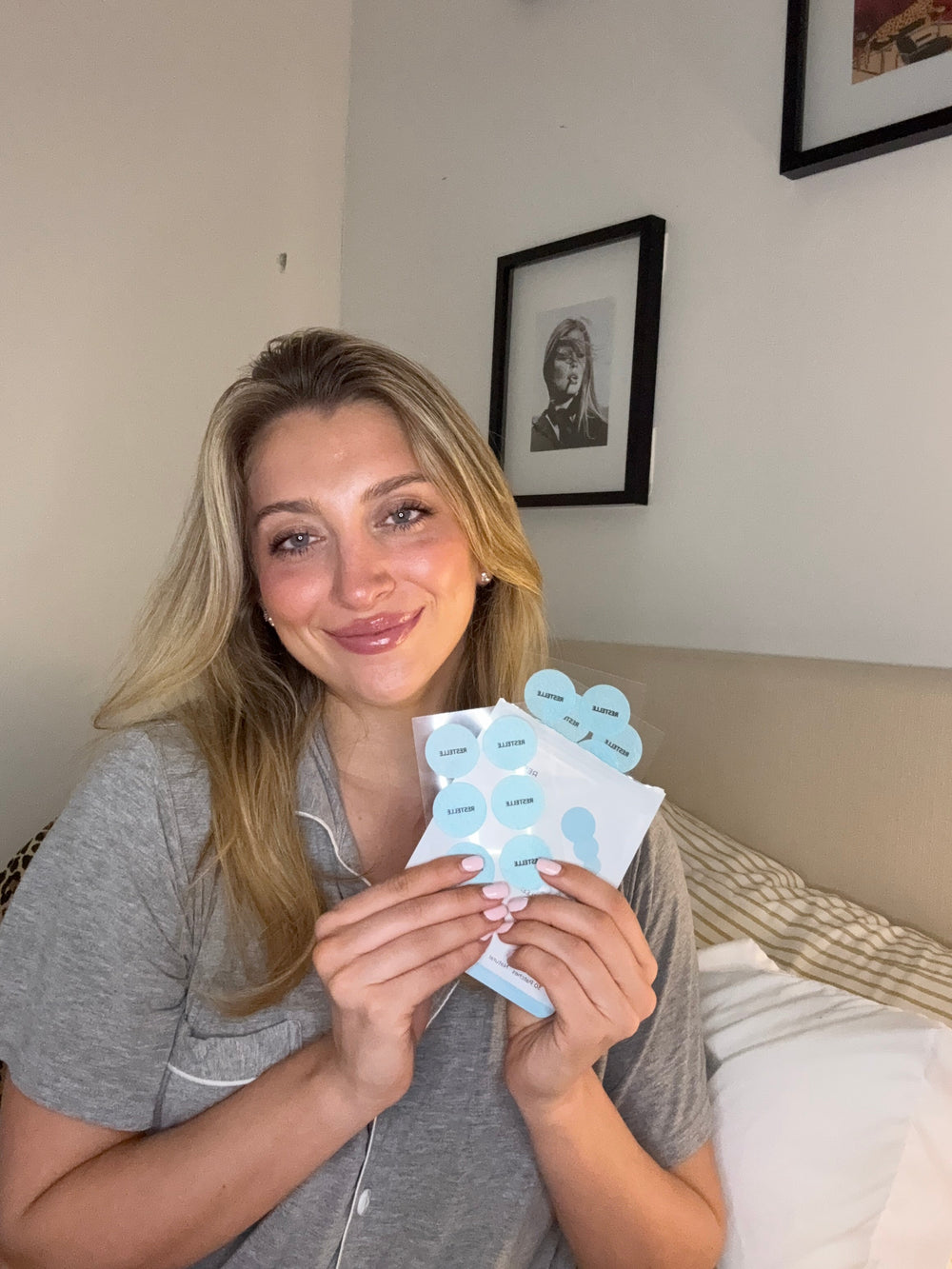 A customer holding a sheet of Elanessa Sleep patches.