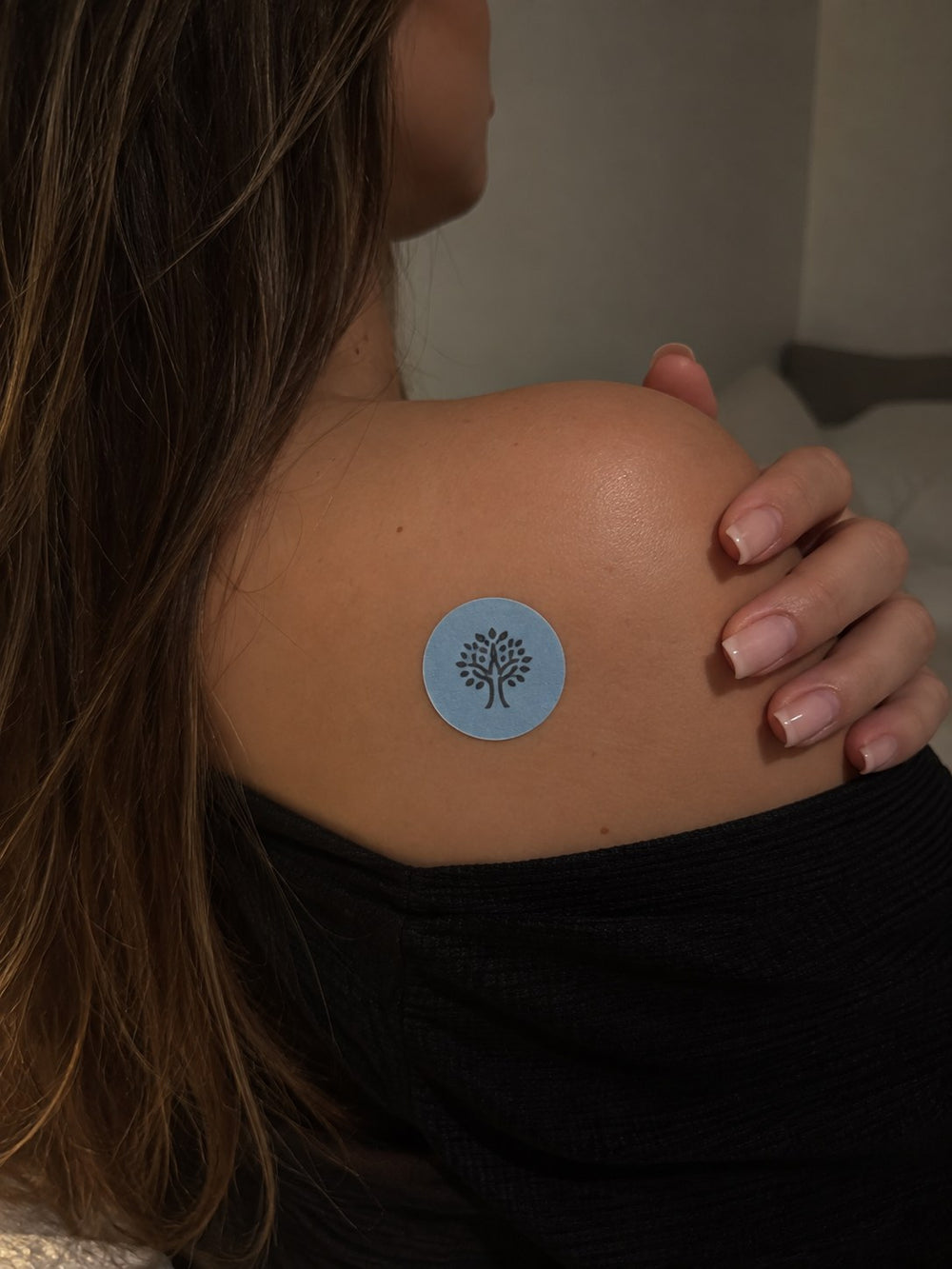 An Elanessa Sleep patch worn on the shoulder.