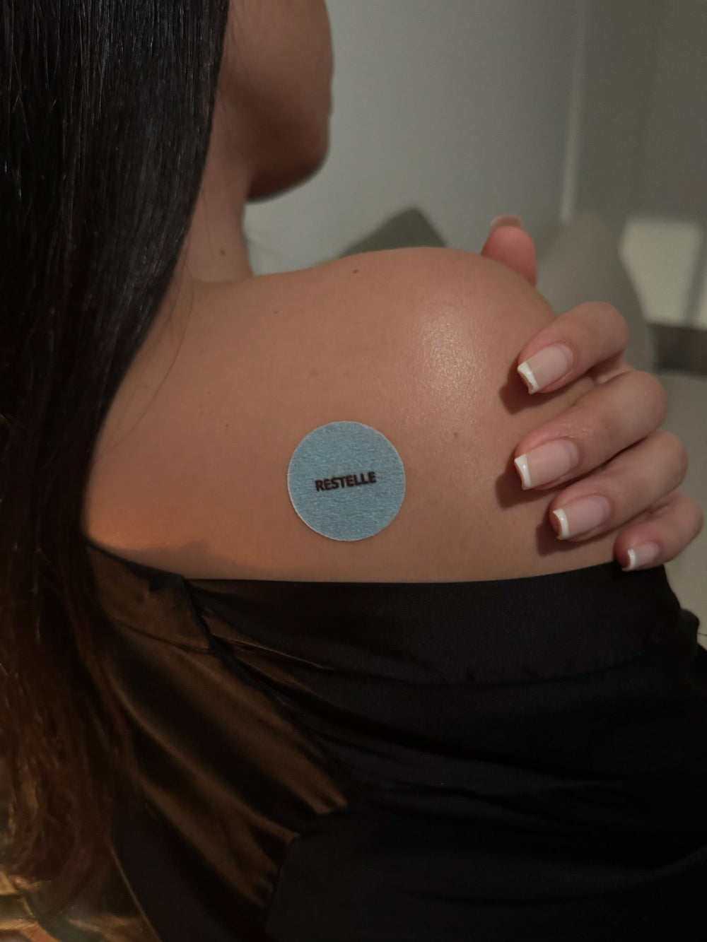 An Elanessa Sleep patch worn on the shoulder.