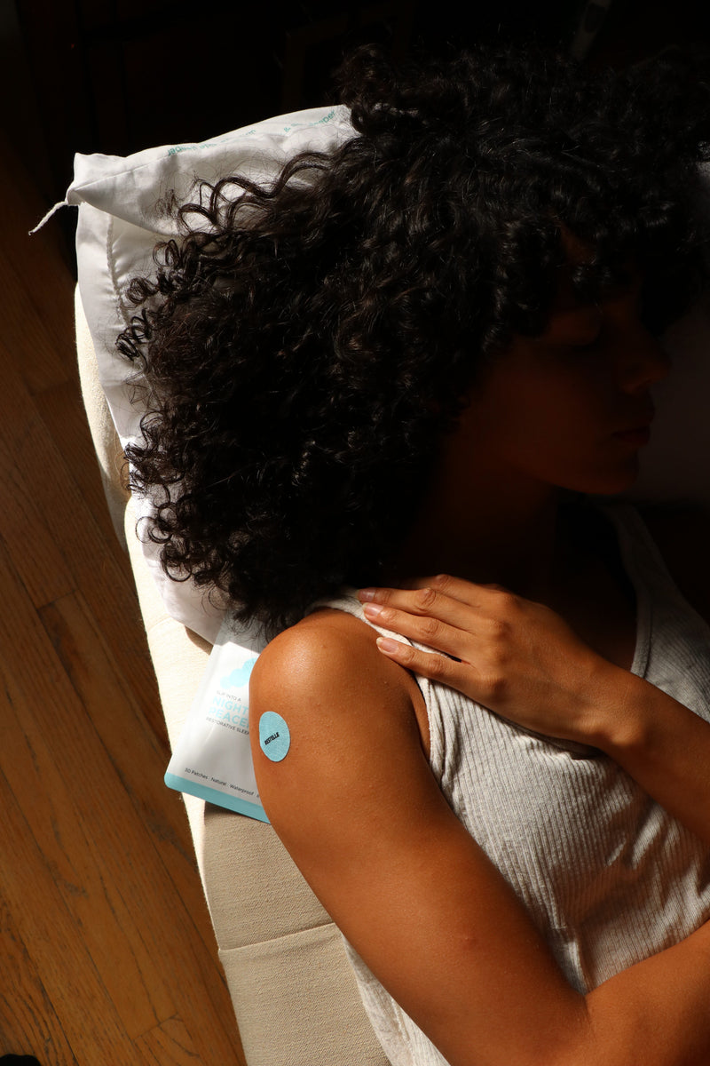A customer applying a Sleep patch to her shoulder.